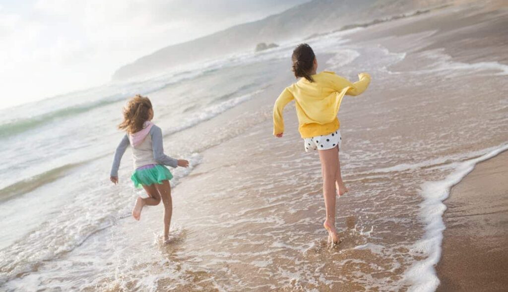 Girls running on beach